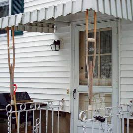 What can be said about this picture? If those crutches ever slip out, the owner will need to use them for their intended purpose, and not as an awning support.