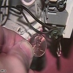 As we compare the color of a penny to the wire you can see the difference, but BE CAREFUL not to touch anything.